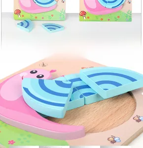 Detail of wooden snail puzzle for toddlers featuring a layered blue shell and base