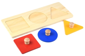 Detail of wooden Montessori puzzle with colorful geometric shapes and easy-grip knobs