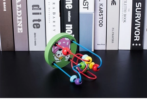 Close-up of wooden bead maze toy with colorful metal tracks and cartoon mushroom base