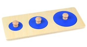 Detailed view of Montessori wooden peg puzzle with three blue circles in varying sizes