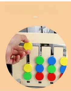 Detail of wooden logic puzzle board showing hand moving colorful fruit sliders for toddlers