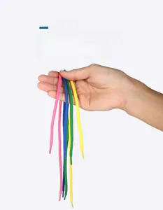 Close-up of colorful cotton threading ropes with plastic tips for wooden sewing toys