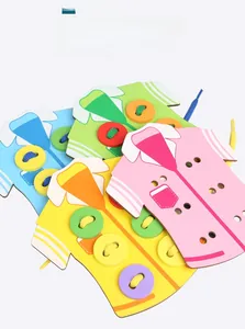 Close-up of colorful wooden shirt boards and buttons for kids threading game