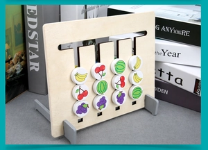 Detail view of wooden Montessori logic slider game with fruit pattern tokens