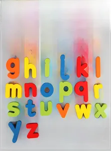 Close-up of 26 colorful wooden lowercase letters for kids spelling and alphabet learning