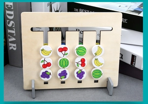 Detail of wooden Montessori puzzle with colorful fruit sliders and natural texture