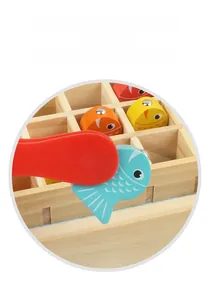 Detail of wooden magnetic fish and red pincer tool for fine motor skills training