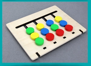 Detail of wooden logic slide puzzle with red yellow blue green blocks for early learning