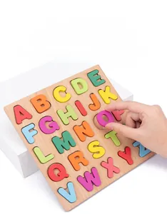 Close-up of a hand picking colorful wooden alphabet letters from a Montessori puzzle board