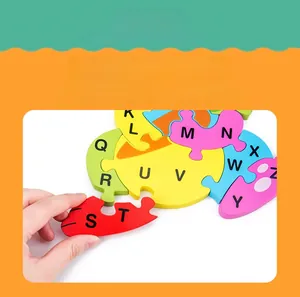 Close-up of child holding colorful wooden alphabet puzzle pieces for early learning