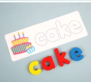 Close-up of wooden letters and educational card for learning the word cake