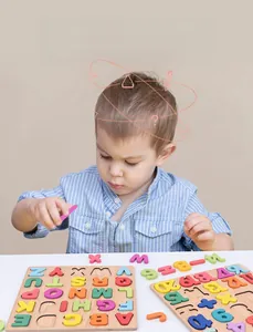 Close-up of a child playing with colorful wooden alphabet and numbers puzzle set