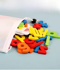 Macro view of colorful wooden letters spilling from a white mesh storage bag