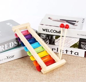 Detail of wooden 8-note xylophone with colorful metal keys and two mallets for toddlers