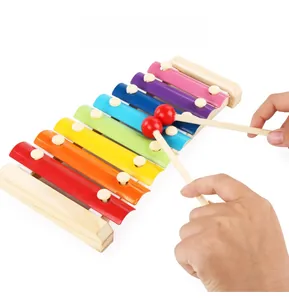 Macro detail of kids eight-tone wooden xylophone with colorful metal keys and two mallets