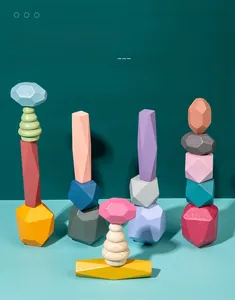 Close-up of Morandi colored wooden stacking blocks in various geometric and gemstone shapes