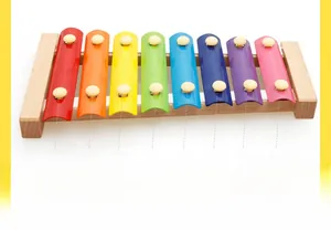 Detail view of colorful 8-note metal keys on a wooden xylophone for early music education