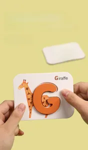 Close-up of large wooden alphabet puzzle card featuring a giraffe and smooth pieces