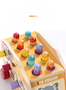 Close-up of wooden whack-a-mole toy with ten colorful ice cream shaped pegs for kids