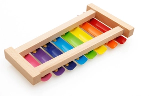 Macro view of colorful 8-note metal keys and smooth wood frame on children's xylophone