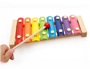 Detail view of colorful 8-note xylophone with wooden mallet for toddler musical education
