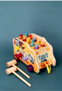 Detailed view of yellow wooden ice cream truck whack-a-mole toy with two hammers