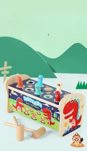 Close-up of wooden dinosaur whack-a-mole toy with dual hammers for kids training