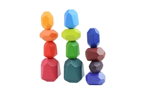 Close-up of colorful wooden balancing stones showing natural wood grain and vivid paint finish