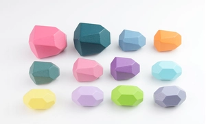 Detailed view of 12 colorful faceted wooden stacking stones with a smooth matte finish