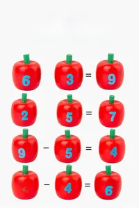 Close-up of wooden apple math toys featuring printed numbers and basic operator signs