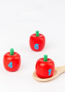 Macro detail of wooden apple blocks with numbers and a matching spoon for math learning
