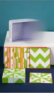 Macro view of wooden logic blocks with white tin box and geometric puzzle cards for toddlers