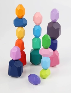 Macro shot of colorful wooden balance stones stacked in three creative towers