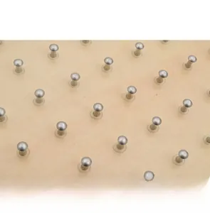 Close-up of secure metal pins embedded in a solid wood geometric geoboard for kids