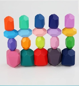 Detailed view of colorful wooden balance stones stacked in multiple creative columns