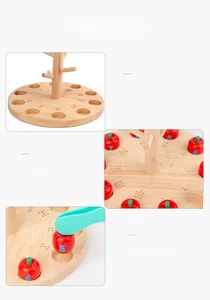 Macro detail of wooden apple tree math toy with number sorting slots and green tweezers