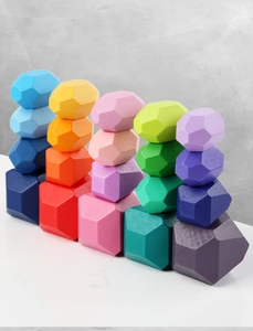 Close-up of multi-colored wooden balancing stones with smooth faceted gem-like shapes
