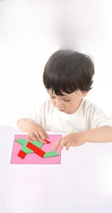 Toddler playing with colorful wooden geometric magnetic puzzles and logic challenge cards