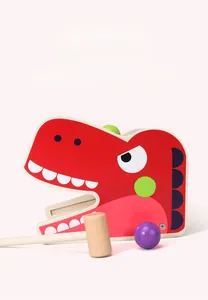 Detail of red wooden dinosaur pounding toy with mallet and ball for motor skills