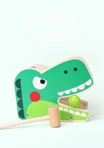 Detail view of a dinosaur-shaped wooden pounding toy with mallet for kids' motor skills