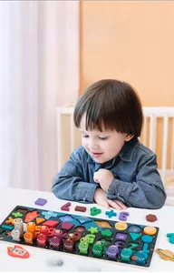 Toddler exploring space-themed wooden puzzle with planets, shapes and numbers