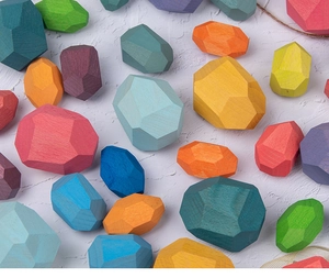 Close-up of colorful wooden balancing stones with natural matte texture and smooth edges