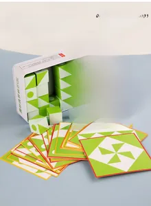Close-up of wooden 3D spatial logic puzzle with green geometric blocks and reference cards