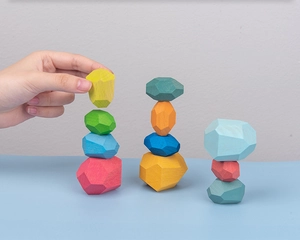 Macro shot of colorful wooden balance stones for kids stacking game and motor skills