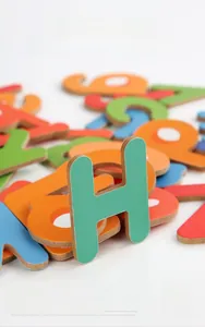 Macro shot of colorful wooden alphabet letters for early educational word puzzle games