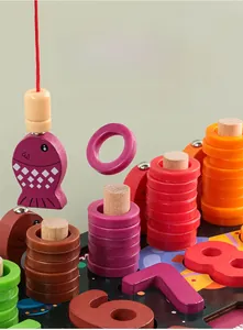 Close-up of wooden Montessori toy featuring magnetic fishing game and color stacking rings