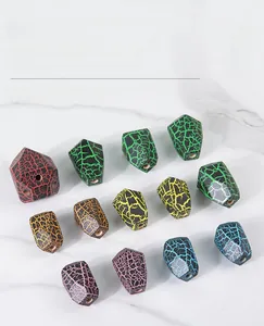 Detail of colorful faceted wooden stacking stones on a light marble surface
