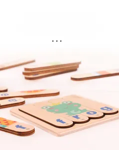 Detail of laser-cut wooden frog puzzle showing smooth edges and letter-word matching