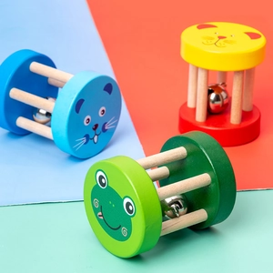Three colorful wooden baby rattles with cartoon animal faces for early music education