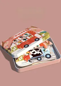 Detail of metal storage box and thick puzzle pieces with cartoon bus illustration